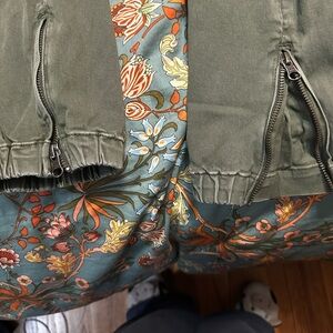 Torrid Olive Green straight leg pants with zipper detail at the ankle